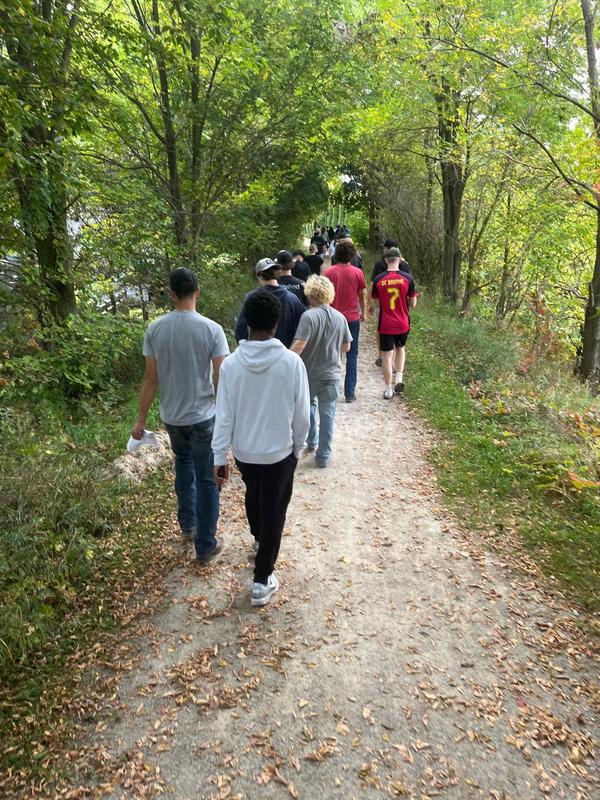 A group of LDSS students walking on a forest trail