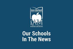 A dark blur poster with the Avon Maitland District School Board logo (an apple inside an open book) and the words “iAM education” above the headline “Our Schools In The News.”