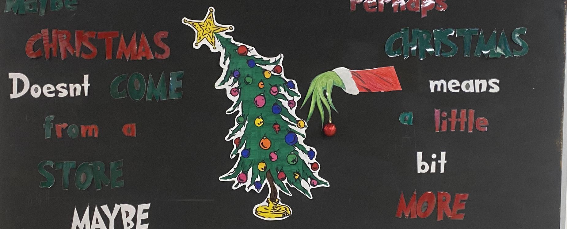 School bulletin board decorated with the Grinch Christmas.