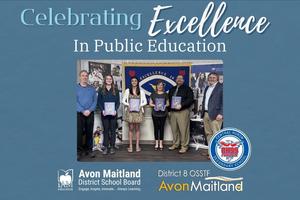 A group of people stand together indoors for a "Celebrating Excellence in Public Education" event, with individuals in the center holding commemorative programs. They are positioned in front of a blue banner that reads "Excellence In". The image is framed by a blue background featuring the logos for the Avon Maitland District School Board, District 8 OSSTF, and the school logo.