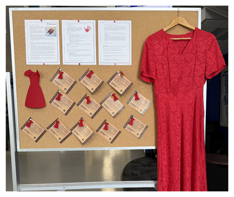 Image of a bulletin board and a red dress on a hanger.