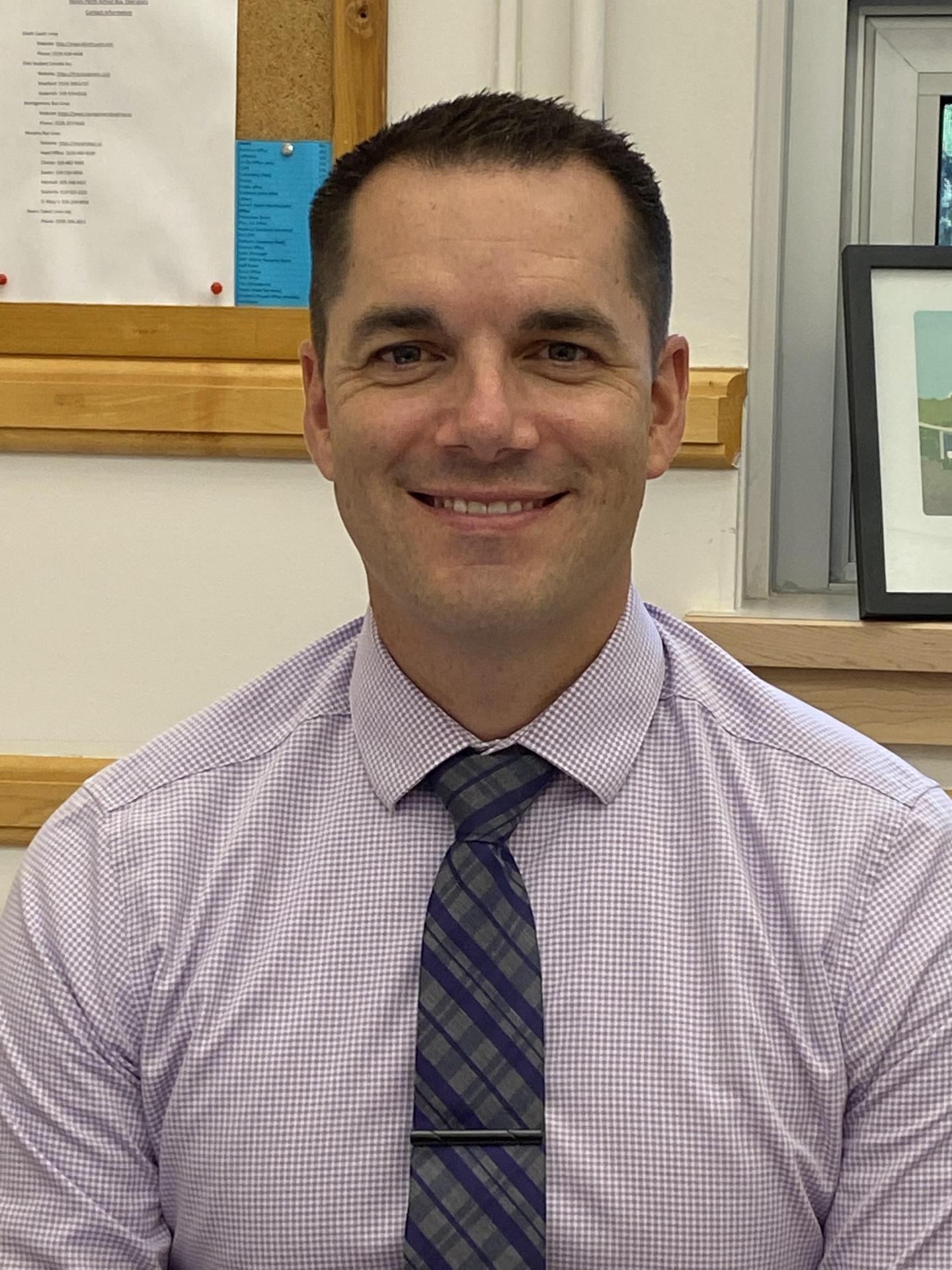 Head and shoulders photo of man wearing a tie