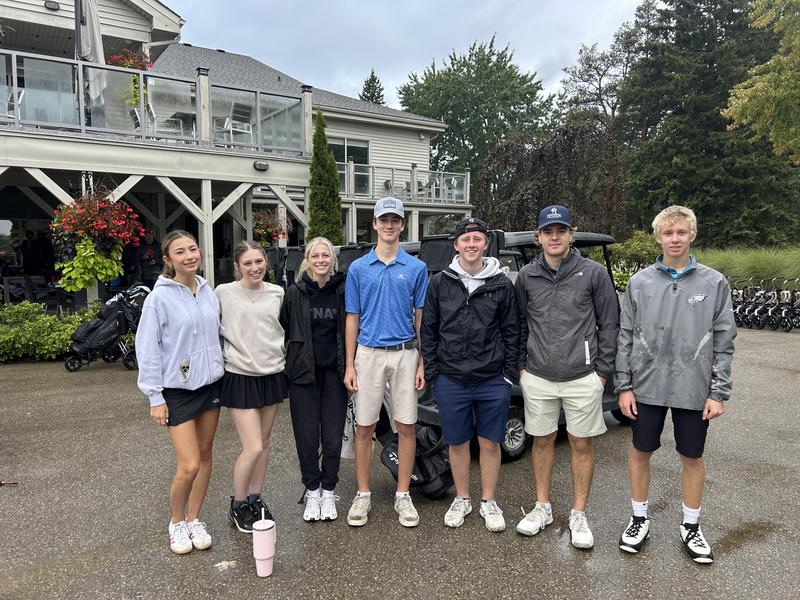 golfers posing for photo