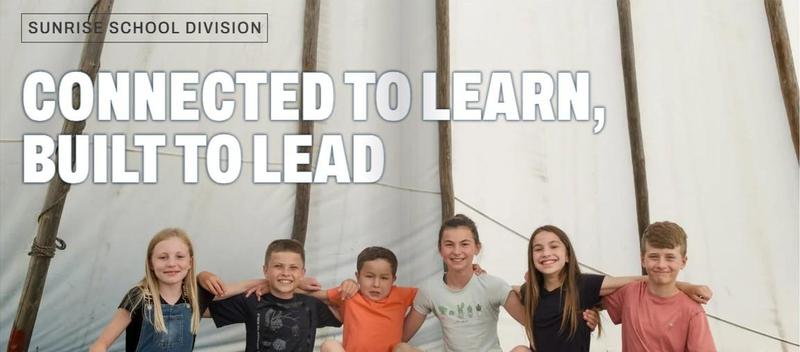 A group of 6 younger students sitting on the ground, arms linked. Wording reads: Sunrise School Division - Connected to Learn, Built to Lead