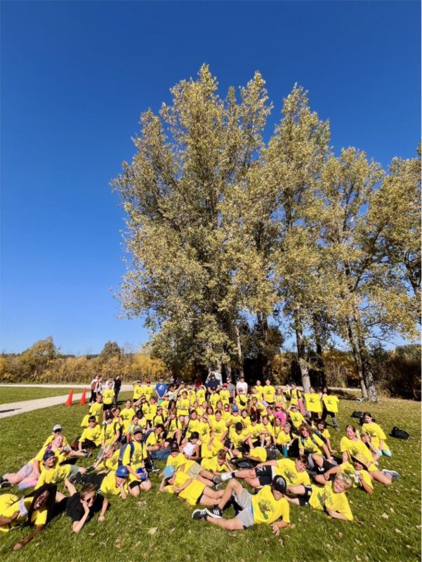 Over 100 students gathered for a group photo in their yellow Beausejour Bears t-shirts at the divisional cross country meet.