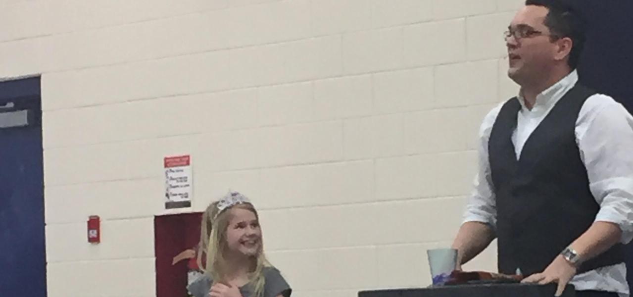 Student in tiara with magician