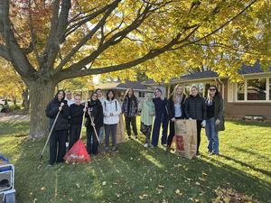 students posing with rakes
