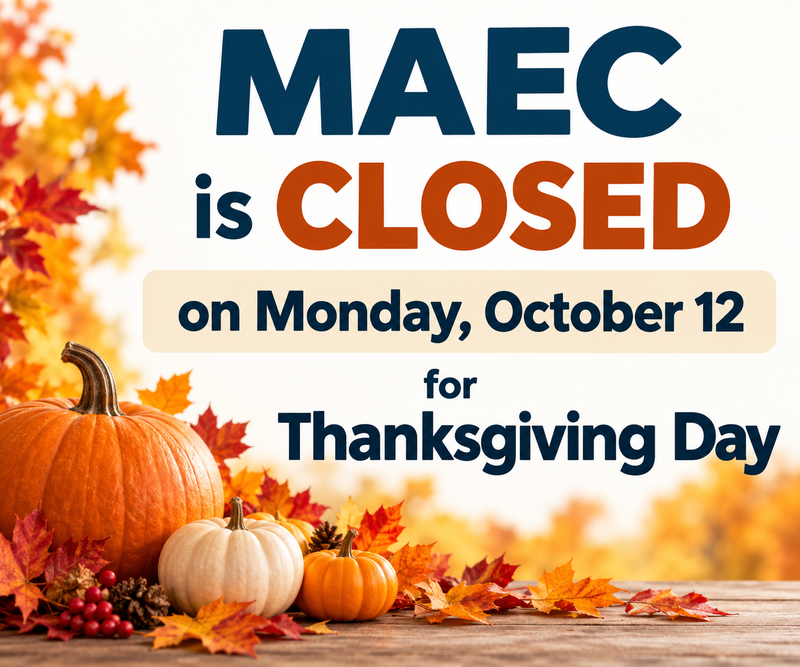 hanksgiving closure sign for Morden Adult Education Centre (MAEC), announcing that the Centre will be closed on Monday, October 12, for Thanksgiving Day. The design features orange and white pumpkins, colourful autumn leaves, and a wooden tabletop.