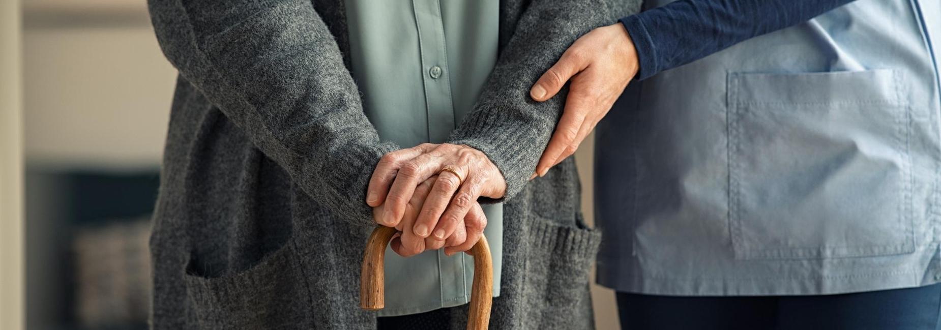 Personal support worker assisting an elderly individual.