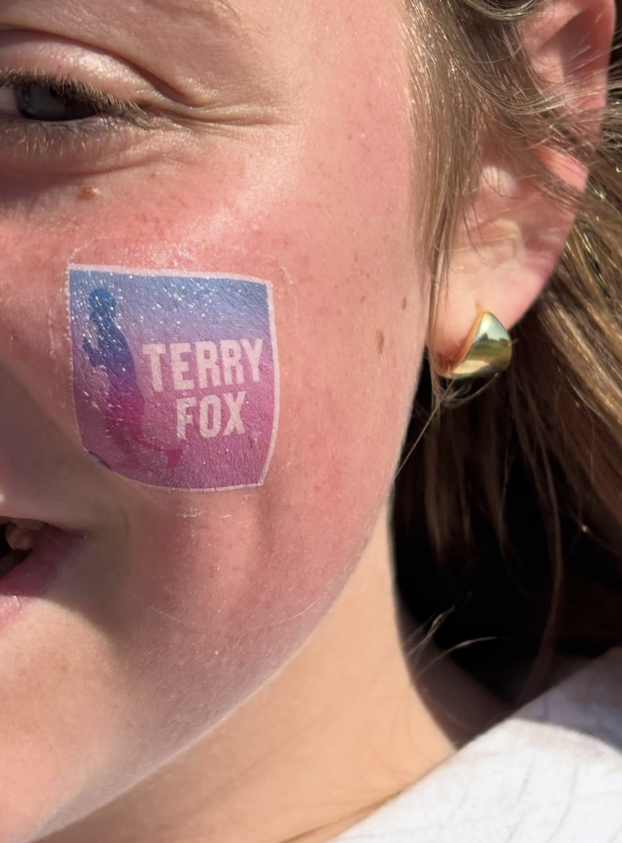 Close-up of girl's cheek with Terry Fox temporary tattoo