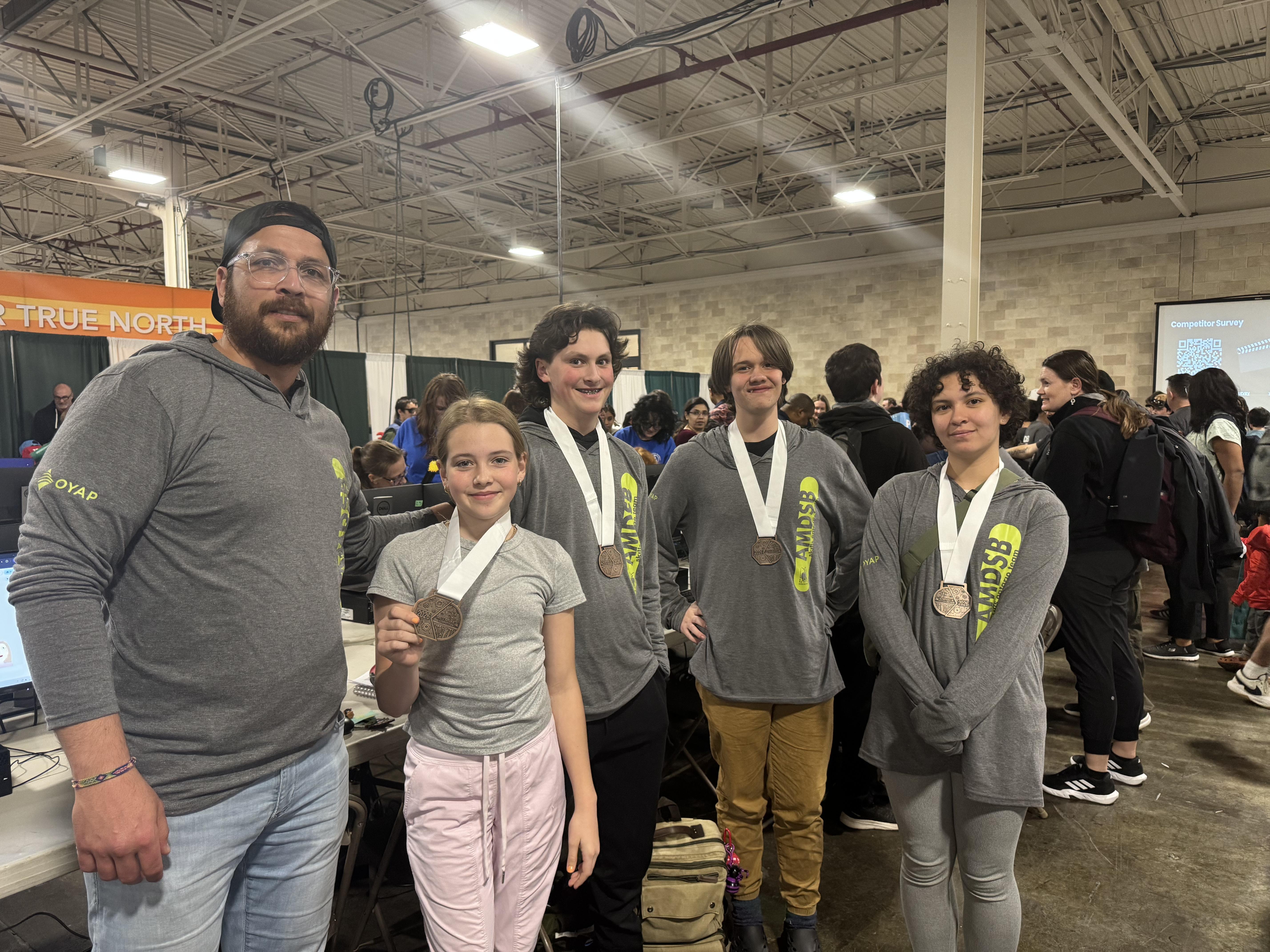 SIS students posing with their bronze medals