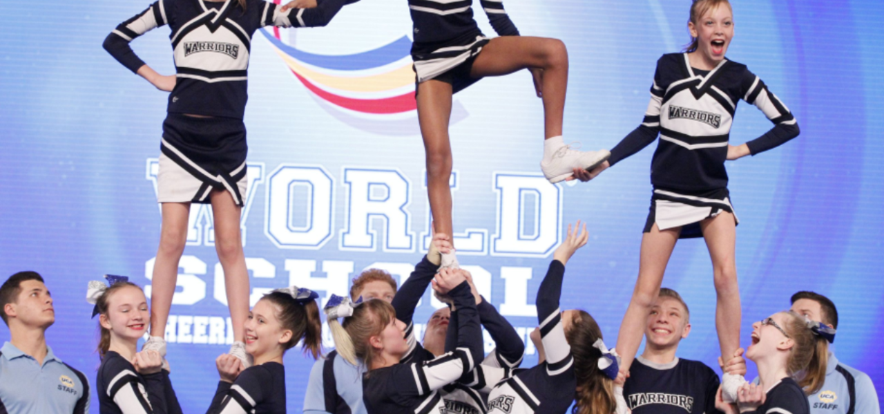 Cheerleaders doing a stunt.