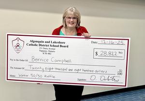 Bernice Campbell holding large cheque.