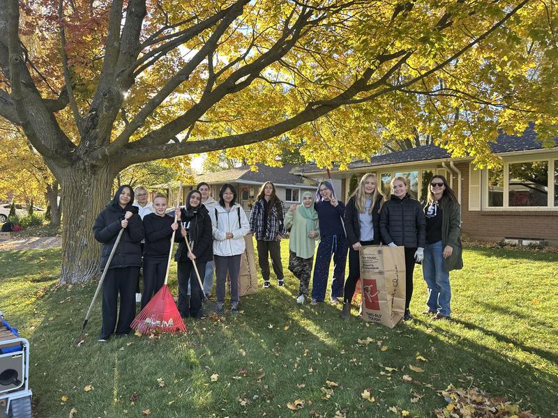 students posing with rakes