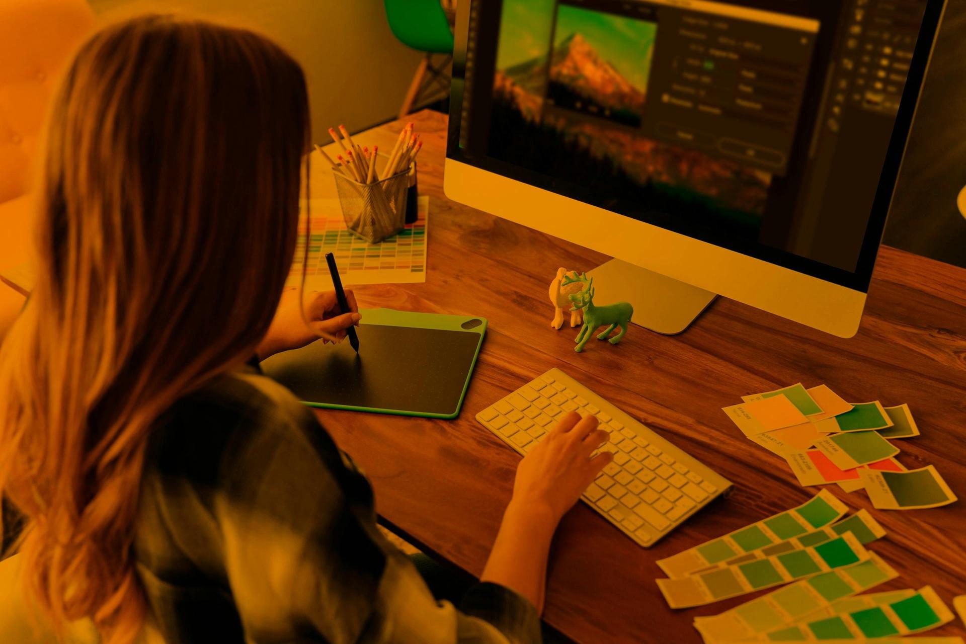 A person using a digital tablet on a computer