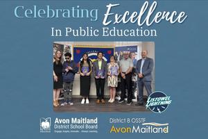 A group of people stand together indoors for a "Celebrating Excellence in Public Education" event, with individuals in the center holding commemorative programs. They are positioned in front of a blue banner that reads "Excellence In". The image is framed by a blue background featuring the logos for the Avon Maitland District School Board, District 8 OSSTF, and the school logo.