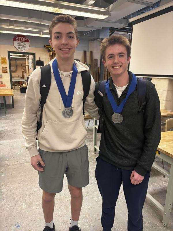 Two male students dawn silver medals