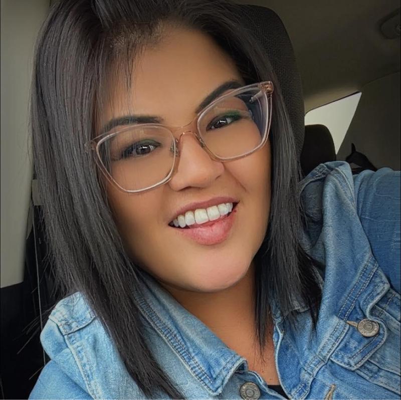 Image of a smiling woman wearing glasses.