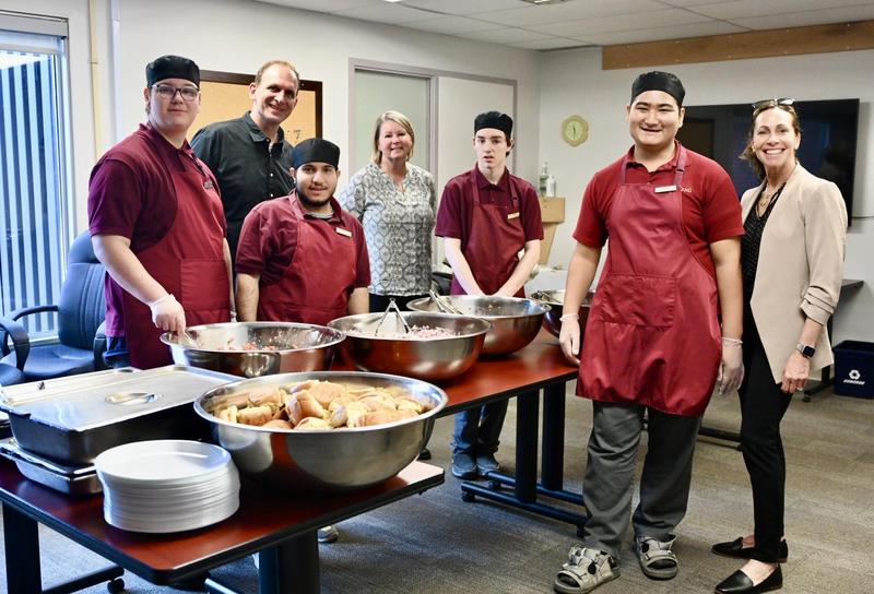Life Skills students and their educators stand with the food they've prepared for the LTM lunch at the Board office in Napanee.