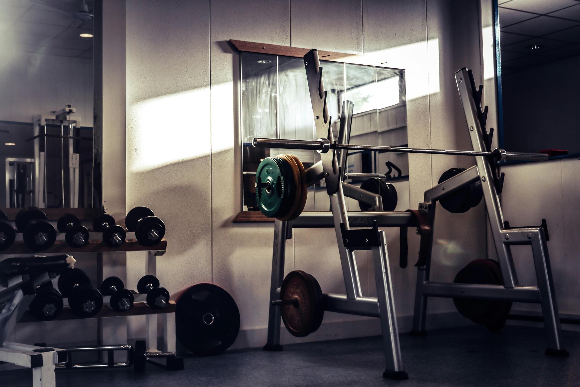 A space with a workout bench and dumbells