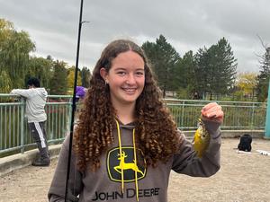 student holding a fish
