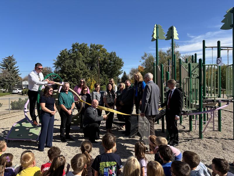 students and dignitaries celebrating the ribbon cutting on the new playground