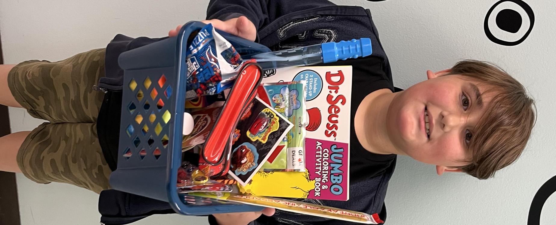 Male student holding prize basket