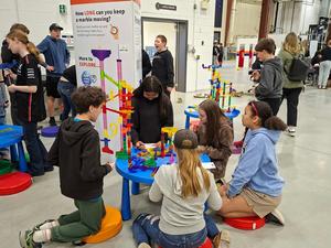 Students sitting around a Skills Expo table