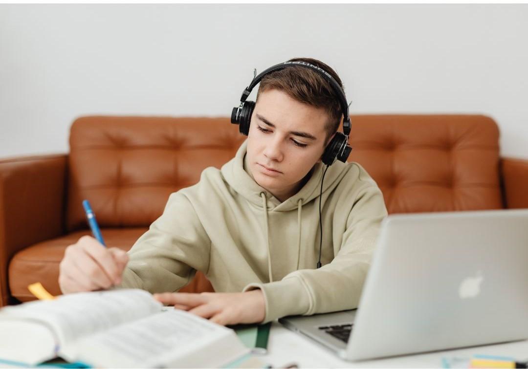 Male student working with headphones on