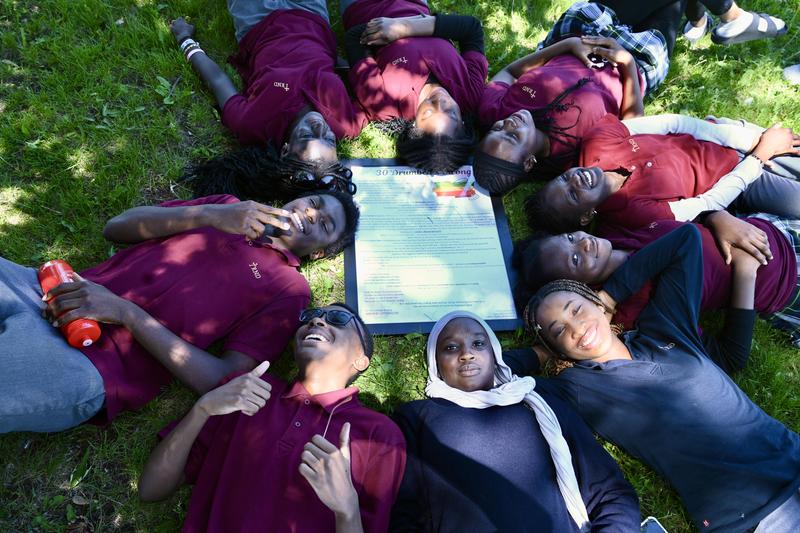 BIPOC students pose with Black History Month poem.