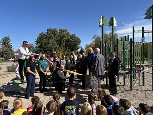 students and dignitaries celebrating the ribbon cutting on the new playground