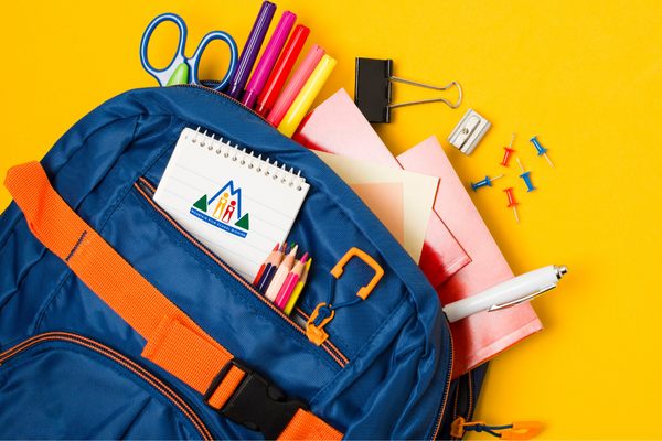 Blue backpack with assorted school supplies within.