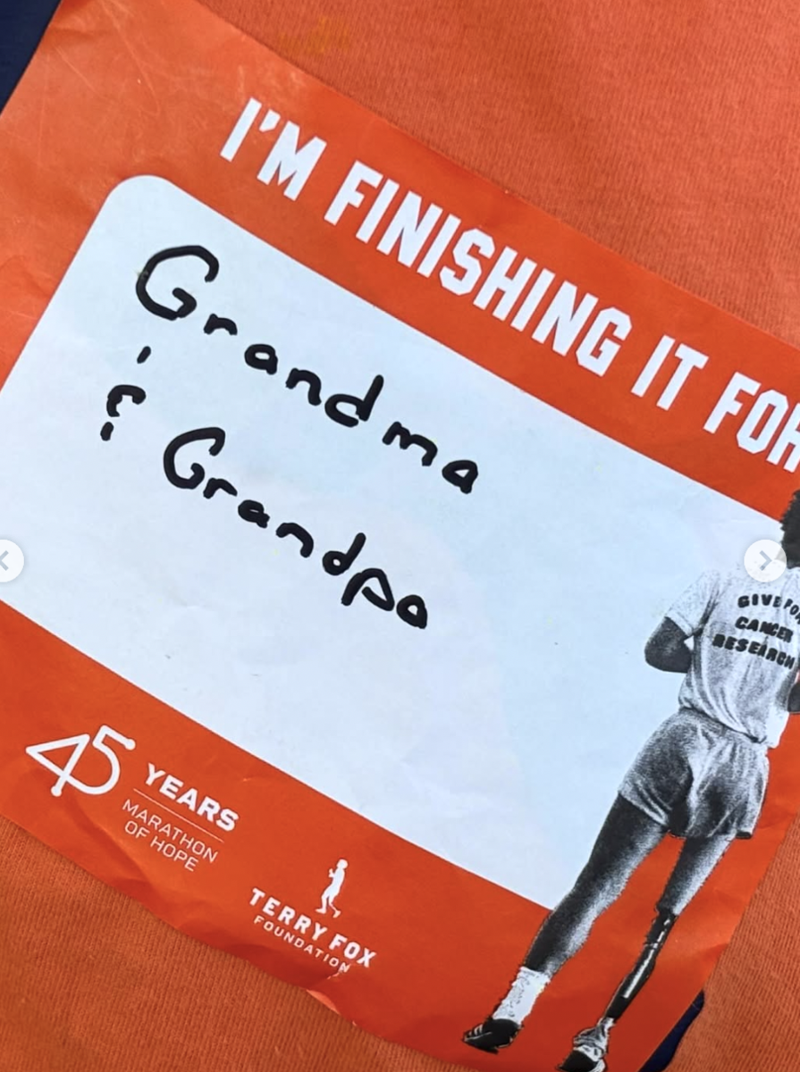 A student's sticker indicating they are finishing the walk for grandma and grandpa