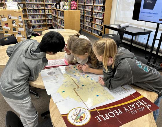 Four students look at a Treaty Map