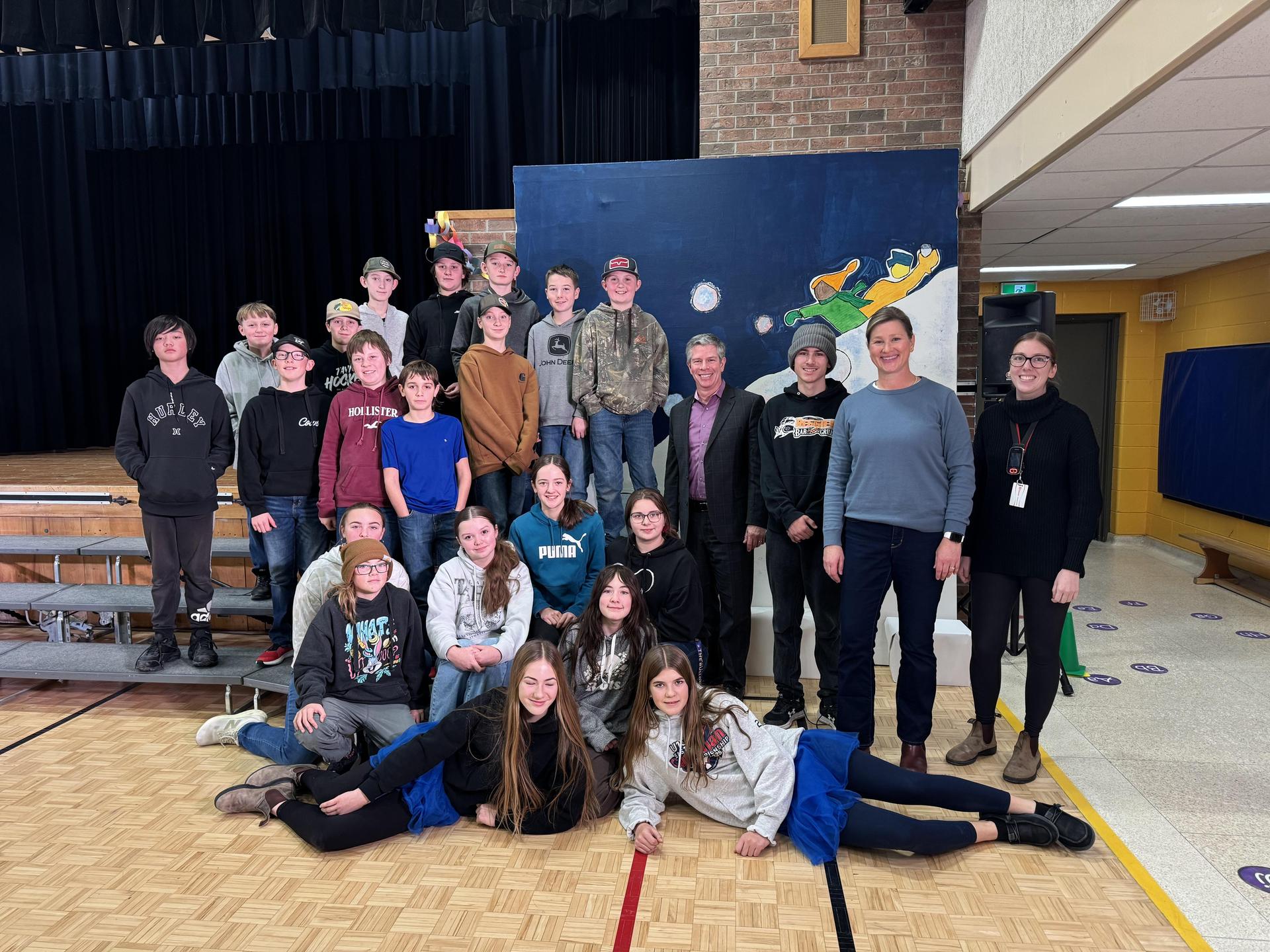Director Shantz posing with North Easthope PS students at their holiday concert dress rehearsal