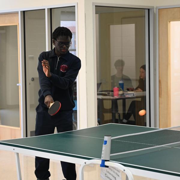 student playing ping pong.