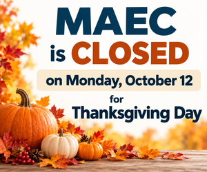 hanksgiving closure sign for Morden Adult Education Centre (MAEC), announcing that the Centre will be closed on Monday, October 12, for Thanksgiving Day. The design features orange and white pumpkins, colourful autumn leaves, and a wooden tabletop.