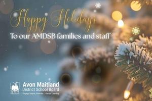 A festive holiday greeting card featuring a close-up of a decorated Christmas tree branch with warm yellow lights and snowflake accents. The background is softly blurred with circular light bokeh. Text on the image reads: “Happy Holidays To our AMDSB families and staff.” At the bottom left, the Avon Maitland District School Board logo appears with the tagline: “Engage, Inspire, Innovate… Always Learning.”