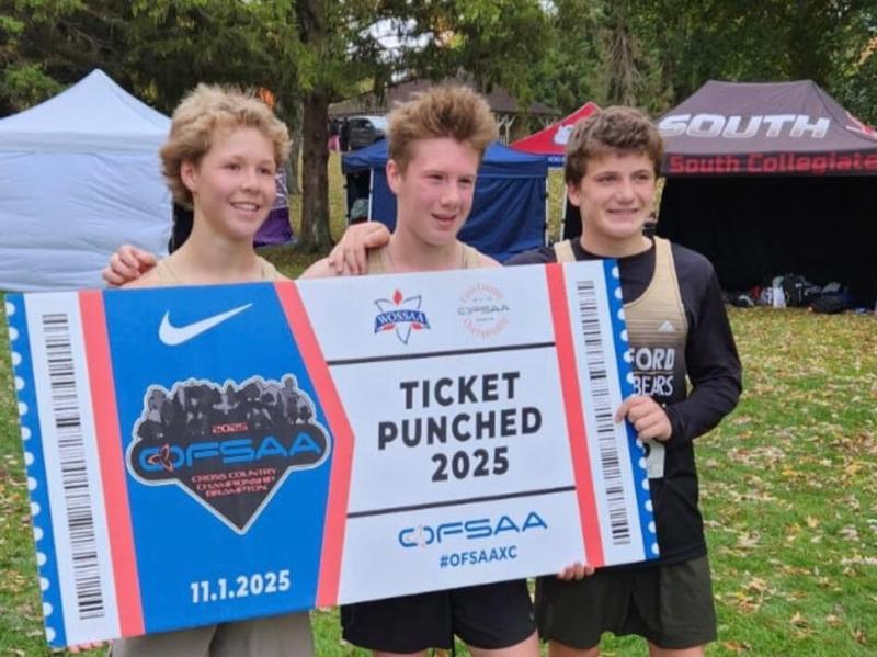 three runners holding OFSSA banner