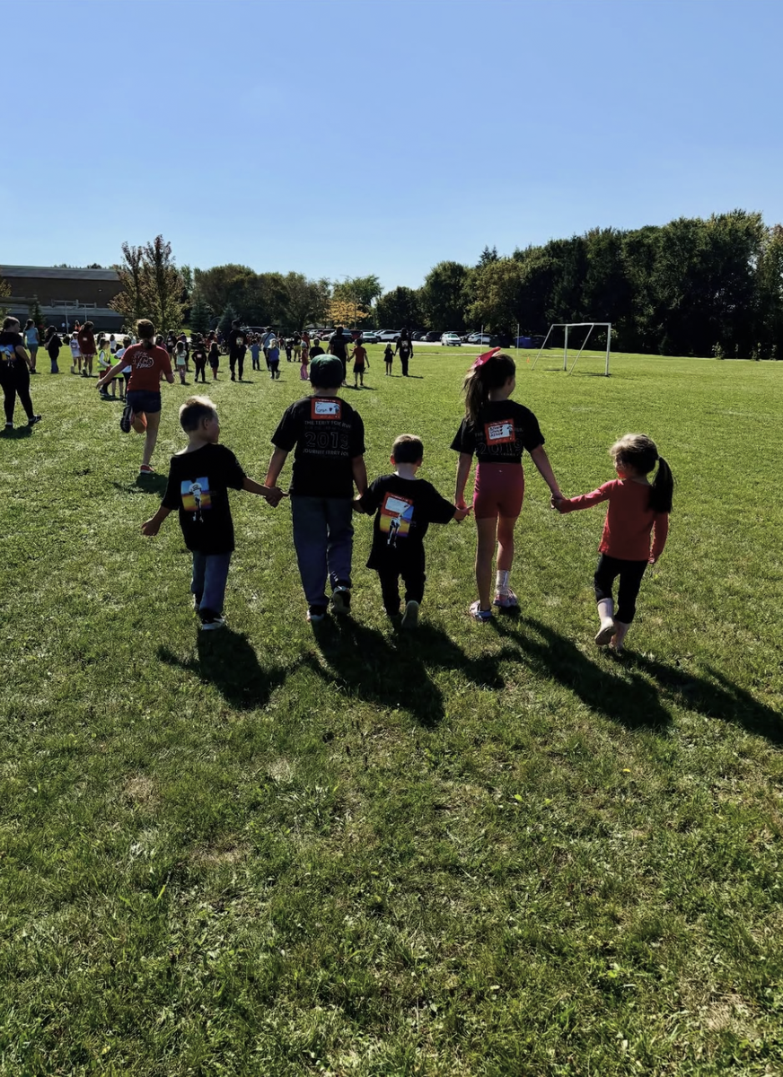 Elementary students holding hands on a Terry Fox walk