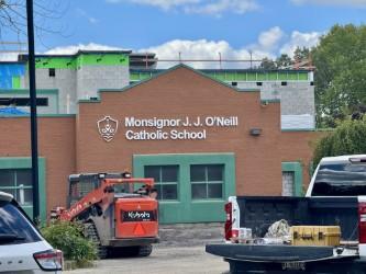 Red brick school with the sign in white font, "Monsignor J.J. O'Neill Catholic School"