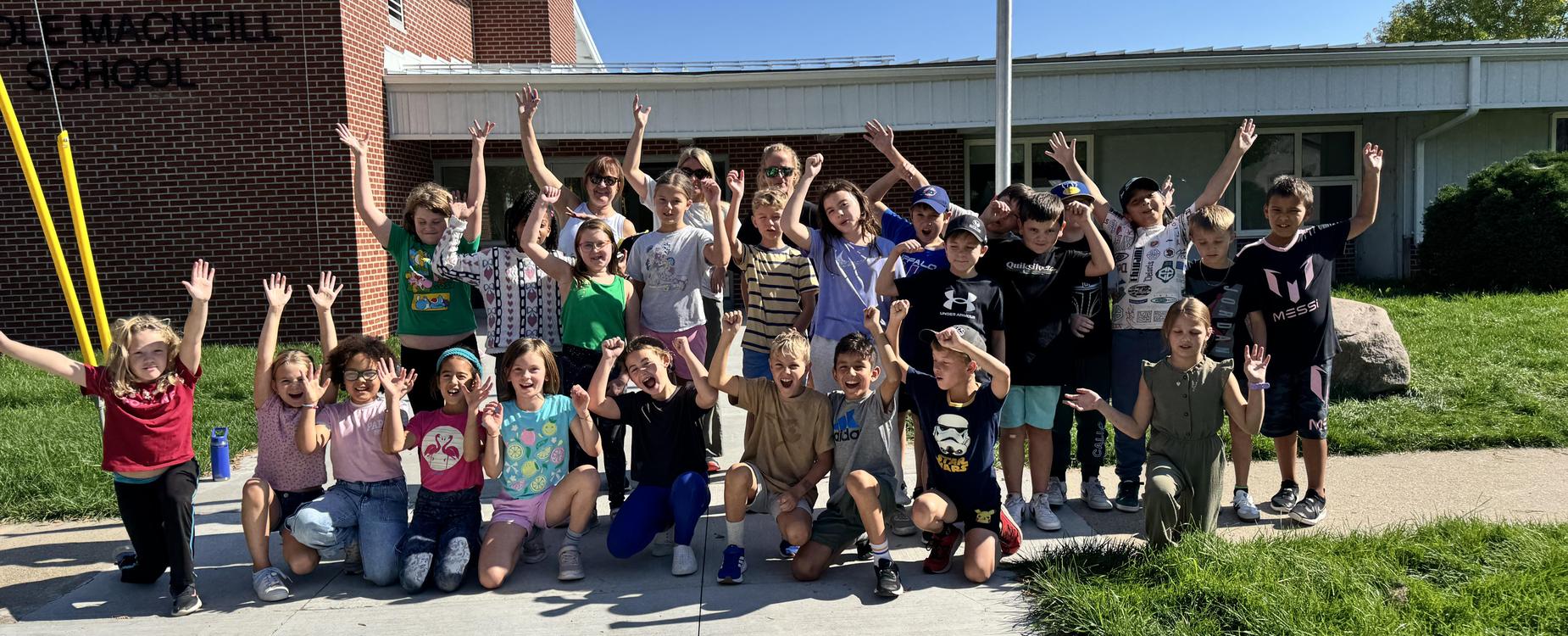École Macneills grade 4 & 5 Running Club. Posing in front of school.