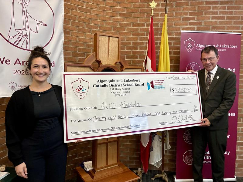 Leila Goyer, Chair of the Algonquin and Lakeshore Catholic Education Foundation and Brian Evoy, Chair of the Board of Trustees holding each end of a large cheque