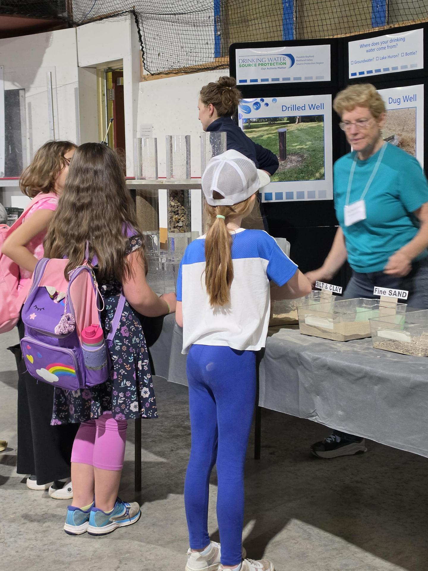 students standing at an educational booth