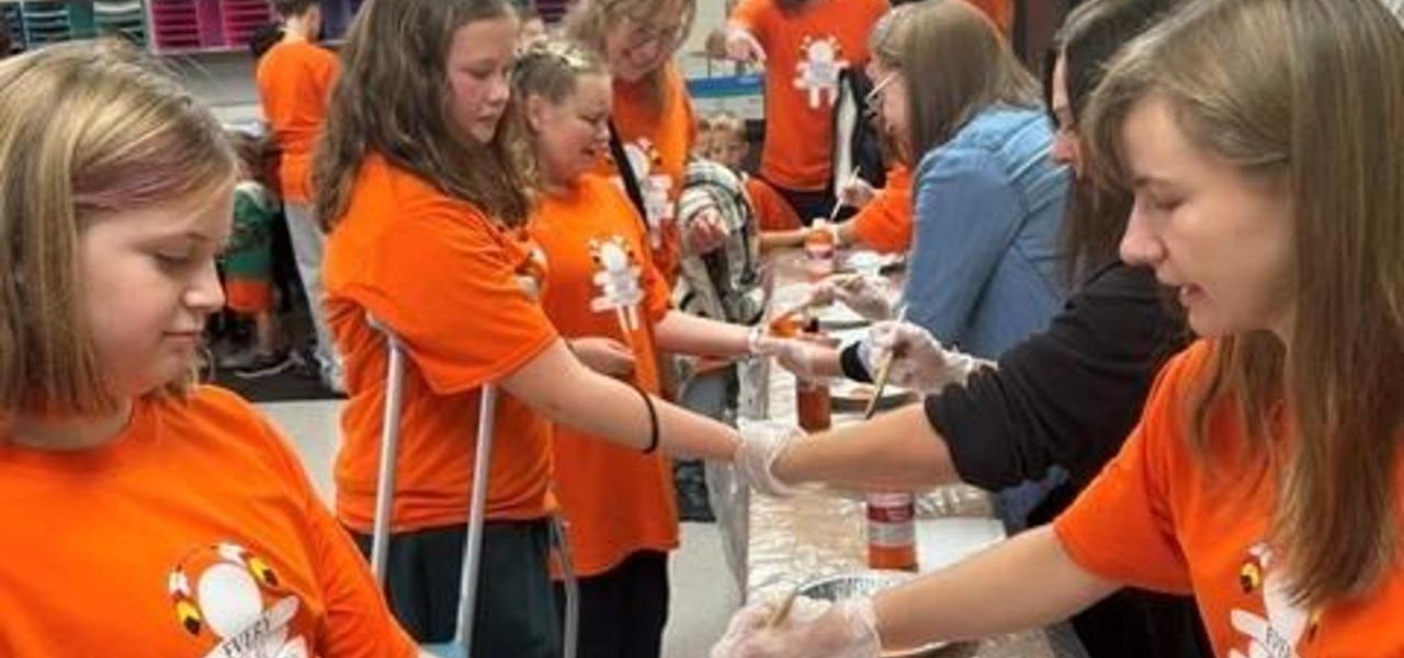 students painting hands