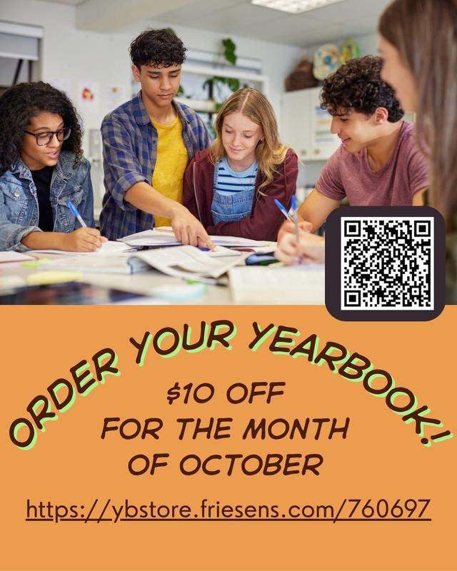 Four students looking at a yearbook