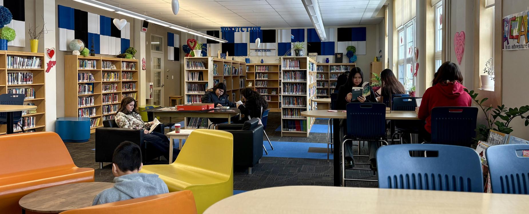 Middle School students reading in a school library.