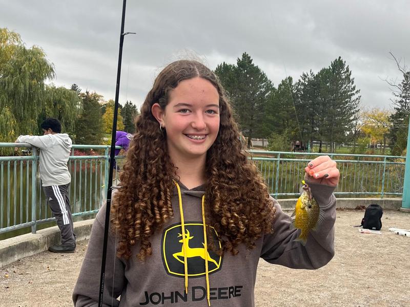 student holding a fish