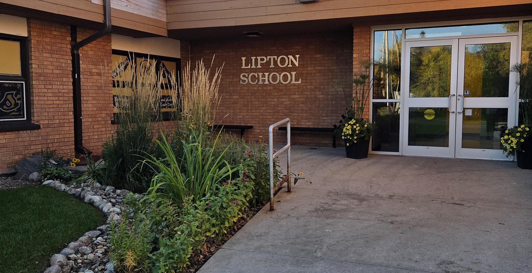 visual image of the outside of the front door of the school