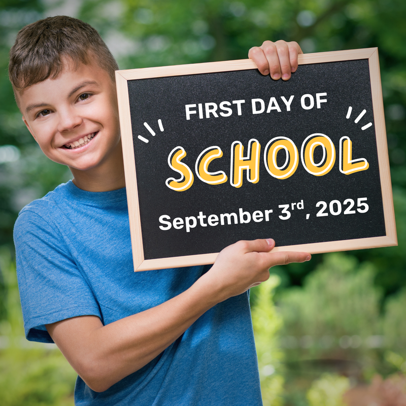 Boy holding a sign that indicates the first day of school is September 3rd